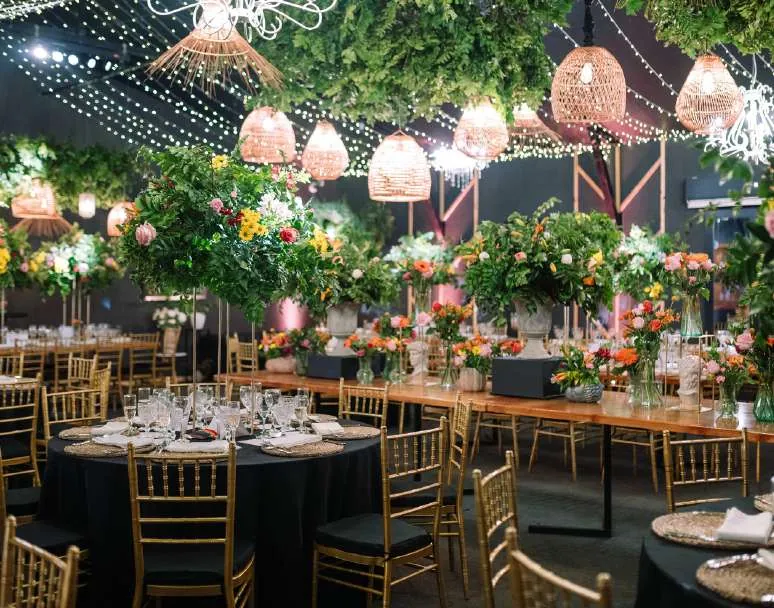 Salón montado para cena de matrimonio con lámparas colgantes